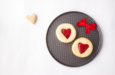 homemade linzer cookies heart-shaped and decorations on white table free space for text - holidays, winter, celebration, Valentine's day concept