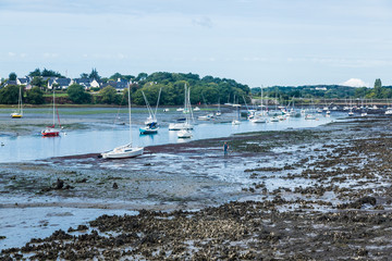 Boats and sailing ships at low tide in the harbour of Larmor-Plage, Lorient, France