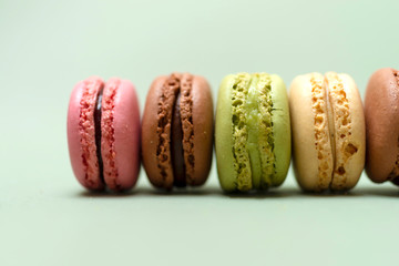 Front view of colorful macaroons on a marble background