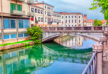 Fototapeta na wymiar bridge over water canal in Treviso city, Italy