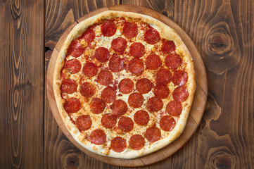 Pizza pepperoni with tomatoes, bacon and olives, top view