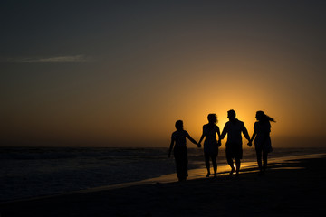 silhouette of family at sunset