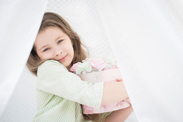 Naklejka premium Close up portrait of beautiful little girl with bouquet of flowers for mothers. Happy mothers day concept.