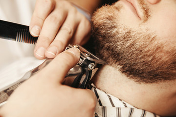 Bearded hipster trim beard in men hair salon