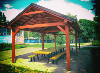 Fototapeta na wymiar Picnic shelters in a beautiful park, blurred image.