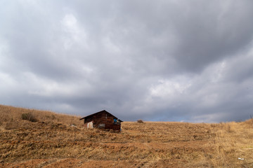 A rural landscape of a farmland and human settlements or huts