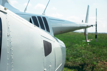 Close-up of rear helicopter propeller. Small light helicopter tail rotor and turbine at blue cloudy sky on background