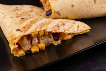 Quesadilla flat cakes with pieces of chicken, corn and black haricot