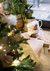 White set with a saucer and a colored mug. Festive Christmas layout.