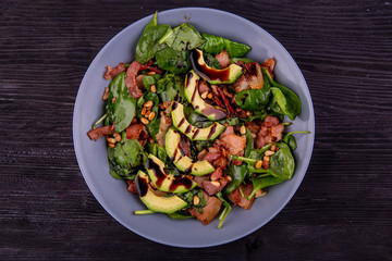 Young spinach salad with boiled language and nutlets