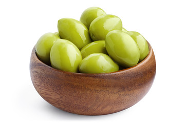 Delicious green ripe olives in a wooden bowl, isolated on white background