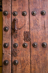 Rustic red door with wrought iron rivets