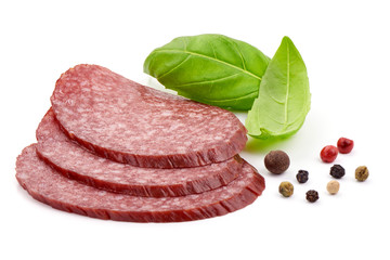 Thin Smoked Salami Slices, basil leaves and peppercorns, close-up, isolated on a white background