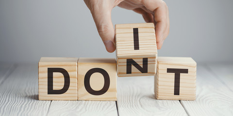 Hand flipping one wooden cube to change the word 