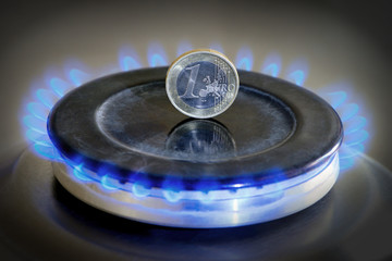 Burning natural gas and one euro coin on gas hob