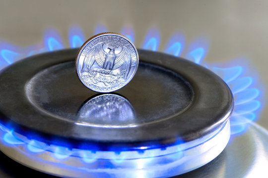 Gas hob with burning natural gas, quarter US dollar coin