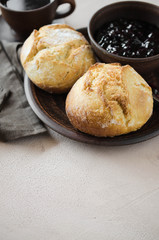 Simple breakfast: coffee americano, fresh buns and jam.