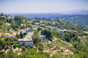 Fototapeta na wymiar Aerial view of residential neighborhood on top of a hill near Pulgas Ridge OSP, San Carlos, San Francisco bay area, California