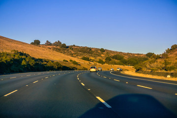 Fototapeta na wymiar Highway winding through hills at sunset, San Francisco bay area,, California