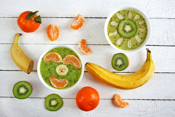 Colorful snack for children and adults - smoothie bowls decorated with fruits
