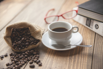 Taza de café, gafas para leer y un libro