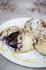 Czech or European typical meal, sweet stuffed dumplings, often with plum, strawberry or another fruit, served with chocolate, cocoa, butter and curd, eaten as a dessert after dish, liked by children