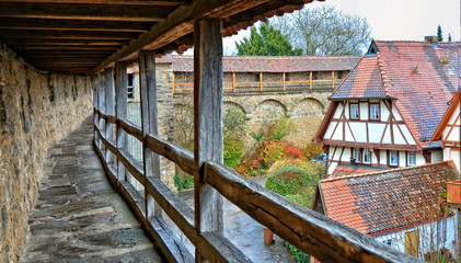Ancient stone wall. Overlook of the old town from the medieval wall. Half-timbered house with red tile roof. German architecture. Germany. Bavaria. Rothenburg ob der Tauber – November 21, 2017