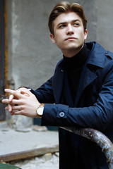 portrait of an attractive young man in a blue suit in the city