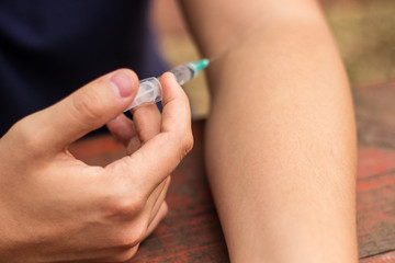 Man addicted with syringe injecting
