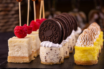 Cheesecakes with lemon mousse, chocolate cream and raspberry