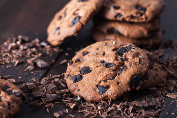Homemade chocolate cookies on dark old wooden table. Chocolate chips cookies shot