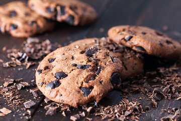 Homemade chocolate cookies on dark old wooden table. Chocolate chips cookies shot