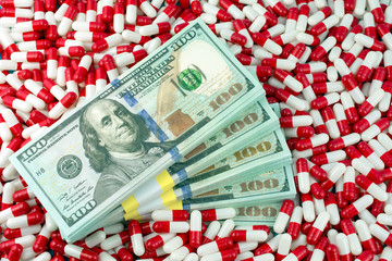 increased drug prices concept. money with pills or capsules. Drug prescription for treatment medication background