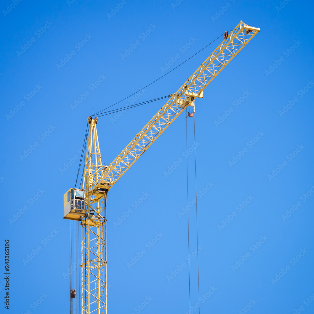 Wall mural construction crane on blue sky background