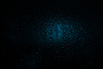 contrast drops on the glass, blue tint, dark fogged glass, texture, background 