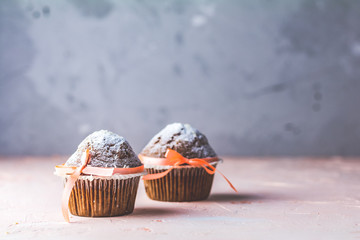 Homemade muffin on light pink living coral stone concrete surfac