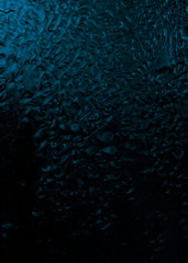 contrast drops on the glass, blue tint, dark fogged glass, texture, background 