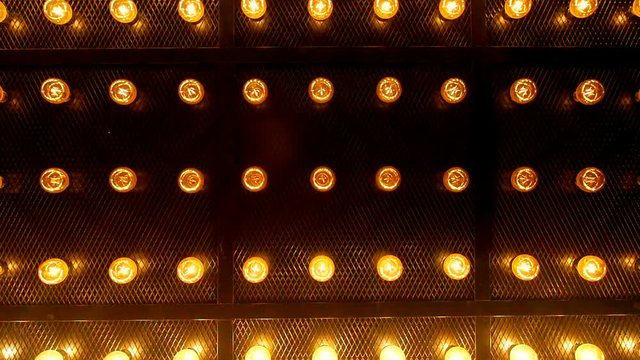 Many bright glowing glass lamps. Illumination of set Edison retro lamps on dark rabitz background. Fashionable loft design with Fashionable loft design with Edison bulbs. Abstract industrial