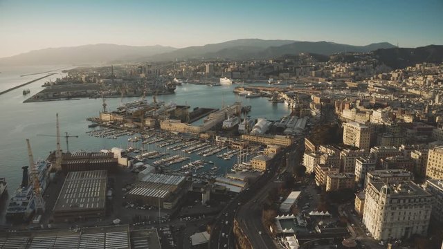 Aerial view of seaport and cityscape of Genoa in the evening, Italy