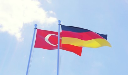Turkey and Germany, two flags waving against blue sky. 3d image