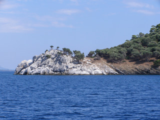 Fototapeta na wymiar Beautiful natural landscape sunny summer day. Panorama of a stone island among the sea,