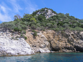 Fototapeta na wymiar Beautiful natural landscape sunny summer day. Panorama of a stone island among the sea,