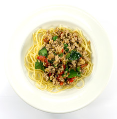Spaghetti Fried Stir Basil with Minced pork in a dish white on floor table, ,food concept,Top view with copy space for your text.