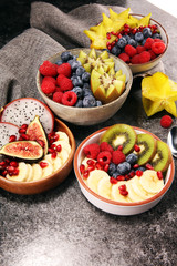 fruit bowl. Bowl of healthy fresh fruit salad on rustic background