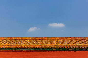Traditional Chinese architecture with red wall and yellow roof tiles, in Forbidden City, under blue sky, in Beijing, China