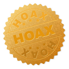 HOAX gold stamp seal. Vector golden award with HOAX text. Text labels are placed between parallel lines and on circle. Golden surface has metallic structure.