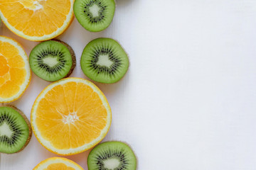 Fresh kiwi and orange sliced. Background for the profile, design, printing with fruit. The basis for the banner with orange and kiwi. Fresh and natkralnye vitamins. Healthy food. Flat lay, top view
