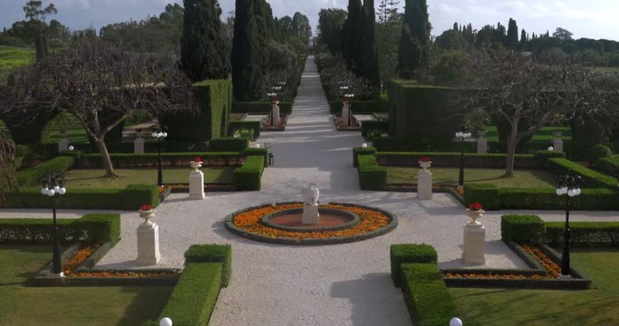 Bahai Gardens landscape design with green lawns and tree-lined alleyway. Acre, Israel
