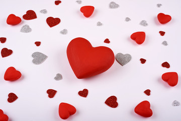 red and silver hearts on a white background around a big red heart. Valentines day.