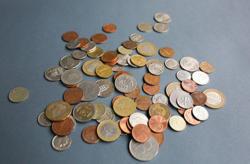 Pile of euro cent coins and dimes lying on the grey background. Money finance economic concept.